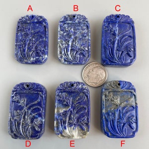 May include: Six carved lapis lazuli pendants with a floral design. The pendants are rectangular and have a hole at the top for hanging. The pendants are labeled A through F.