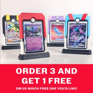 May include: Four rectangular trading card display stands in black, red, light purple, and light blue, each holding a collectible card behind a clear protective cover. The stands feature a circular button detail at the top and white base accents.