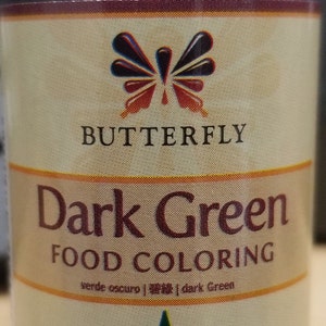 May include: A dark green food coloring bottle with a butterfly logo and the text "Dark Green Food Coloring" on the label. The bottle is 30ml/1.0 oz.