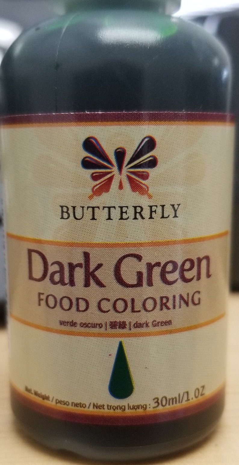 May include: A dark green food coloring bottle with a butterfly logo and the text "Dark Green Food Coloring" on the label. The bottle is 30ml/1.0 oz.