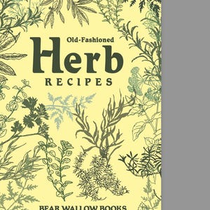 May include: A book cover with the title "Old-Fashioned Herb Recipes" in dark green letters. The cover has a light yellow background with illustrations of various herbs in green and gray. The book is published by Bear Wallow Books.