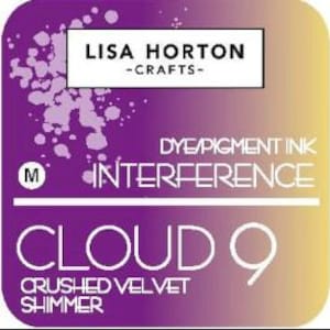 May include: A square label with a gradient background of purple and yellow. The label features the text "LISA HORTON - CRAFTS" at the top, with "DYE/PIGMENT INK" and "INTERFERENCE" in the center, and "CLOUD 9 CRUSHED VELVET SHIMMER" at the bottom. A white circle with the letter "M" is on the left.