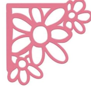 May include: A pink, die-cut metal corner bracket featuring a floral design. The bracket has three stylized daisy-like flowers with open centers and petal shapes. The design is symmetrical and suitable for crafts.