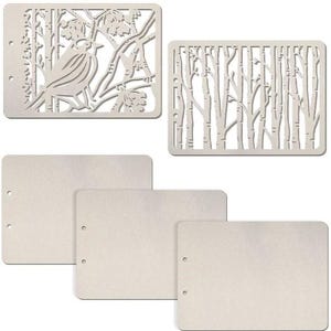 May include: A collection of metal stencils for crafting. Two stencils feature intricate tree and bird designs, while the other three are blank rectangles with pre-drilled holes. The stencils are a neutral silver color.