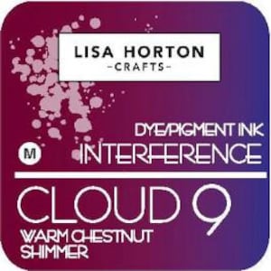 May include: A square label with a gradient background of purple and burgundy. The label features the text "LISA HORTON - CRAFTS" in a white rectangle. Below, it reads "DYE/PIGMENT INK INTERFERENCE CLOUD 9 WARM CHESTNUT SHIMMER."