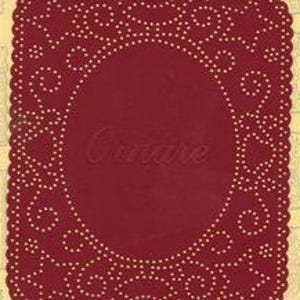 May include: A rectangular deep red paper craft template with rounded corners, featuring a central oval cutout area and an intricate border pattern of small punched holes arranged in swirling and decorative motifs, with the word Ornare visible.