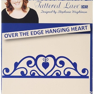 May include: A blue and white die-cut craft product package. The package features a woman's photo, the text "Tattered Lace DIES," and "OVER THE EDGE HANGING HEART." The design includes a heart-shaped motif.