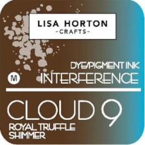 May include: A square, two-toned ink pad with a brown and teal gradient. The text "LISA HORTON - CRAFTS-" is at the top, with "INTERFERENCE" and "CLOUD 9 ROYAL TRUFFLE SHIMMER" below. The ink pad is labeled "DYE/PIGMENT INK".