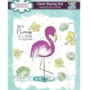 May include: Clear stamp set featuring a flamingo illustration with the text "be a Flamingo in a flock of pigeons." The set includes a flamingo, flowers, and leaves. The stamp set is designed by Bonnita Moaby.