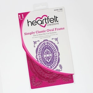 May include: A package of Heartfelt Creations craft dies, featuring an oval frame design. The package includes 11 pieces and is primarily white and pink, with a purple oval frame visible. The text on the package reads "Simply Classic Oval Frame."