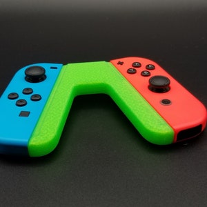 May include: A green, blue, and red Nintendo Switch Joy-Con controller with a textured grip.