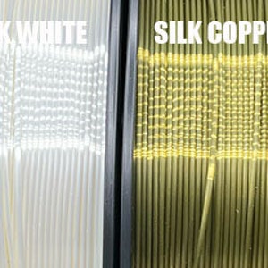 May include: Six spools of filament for 3D printing in various colors, including pink, red, white, copper, green, and red. The filament is labeled with the names "Silk Pink", "Silk Red", "Silk White", "Silk Copper", "Silk Green", and "Twinkling Red".