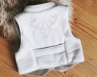 May include: A light gray sleeveless vest featuring a stand-up collar and a horizontal seam across the lower back. The upper back panel displays a dark gray embroidered outline of a deer head with antlers centered between the shoulder blades.