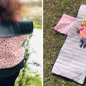 May include: A pink and black polka dot backpack with a black flap. A doll is lying on a pink and white patterned sleeping mat with a gray quilted center.