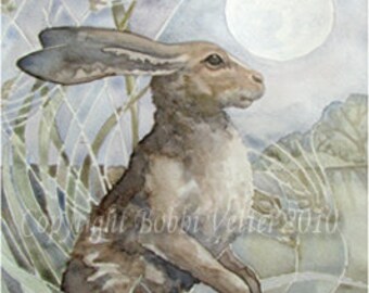 May include: Watercolor painting of a hare in a field under a full moon. The hare is brown and gray, with long ears and is surrounded by tall grass and wheat stalks. The moon is a bright white circle in the sky. The painting is signed "Copyright Bobbi Vetter 2010".