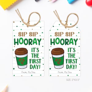 May include: Two coffee-themed gift tags with the text "Sip Sip Hooray It's The First Day!" and a coffee cup graphic. The tags are white with green and brown accents and are 2" x 3.5" in size.
