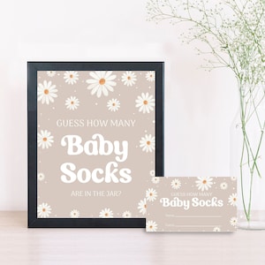 May include: A printable baby shower game card with a beige background and white daisies. The text reads "Guess how many baby socks are in the jar?"