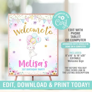 May include: A welcome sign for a first birthday party. The sign features a bunny holding balloons, the text "Welcome to" in gold, and the name "Melisa's" in pink. The sign is on a wooden easel.
