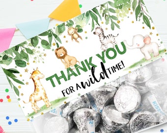May include: Thank you for a wild time! Green and gold favor bag with a jungle animal theme. The bag is filled with silver foil-wrapped chocolate kisses.