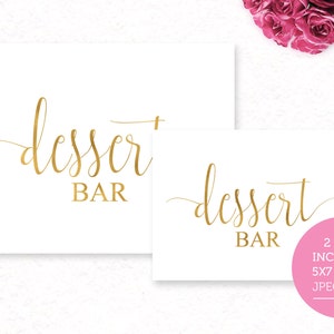 May include: Two printable signs for a dessert bar, one in a 5x7 inch size and the other in an 8x10 inch size. Both signs feature the text "dessert bar" in gold script font on a white background.