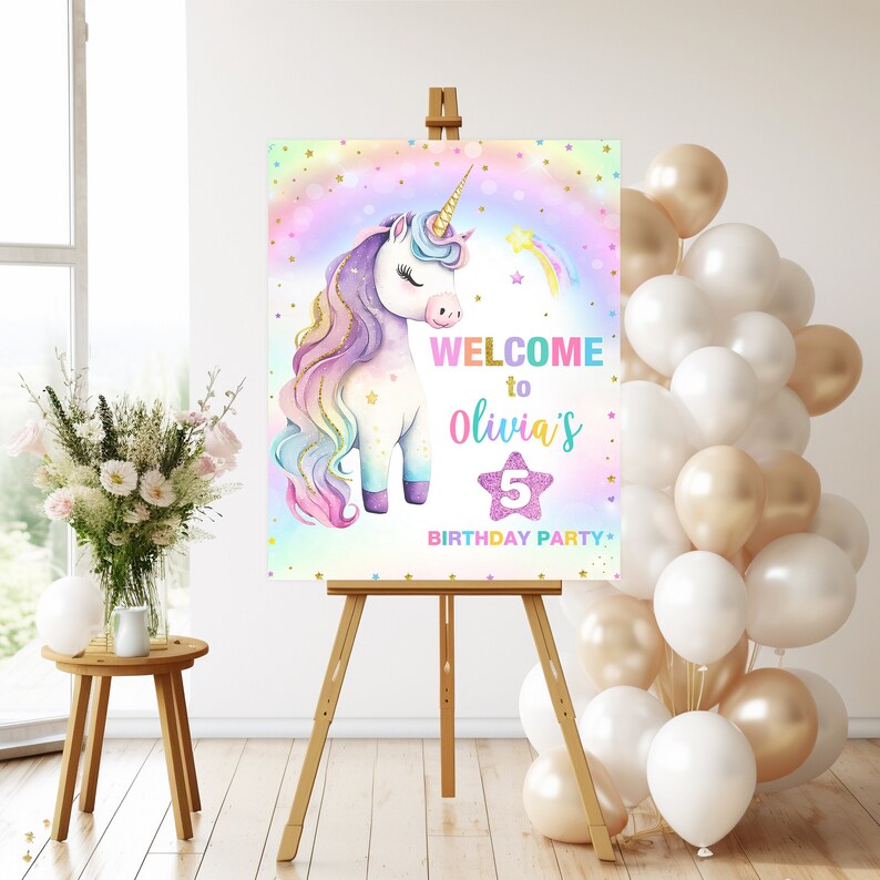 May include: A welcome sign for a unicorn-themed birthday party. The sign features a rainbow background with a white unicorn with a rainbow mane and tail. The text on the sign reads "Welcome to Olivia's 5th Birthday Party".