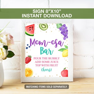 May include: A white framed sign that reads "Mom-osa Bar" with watercolor illustrations of fruit. The sign is 8"x10" and includes the text "Pour the bubbly, add some juice, top with fruit, Cheers!" and "Matching items sold separately."