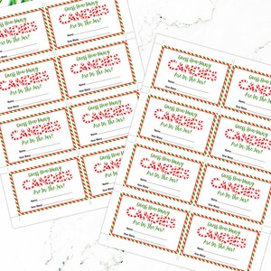 May include: A set of 12 printable guess how many candy canes are in the jar game cards. The cards are white with red and green stripes and the text "Guess How Many Candy Canes Are In The Jar?" in red and green text. The cards have a space for a name and a space to write the number of candy canes guessed.