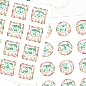 May include: A sheet of white paper with 24 round and square stickers featuring a green and red striped border. The stickers have a gingerbread man and Christmas tree design with the text "North Pole Cookie Co."