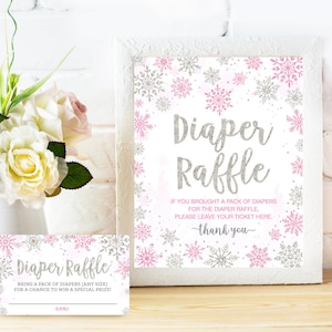 May include: A pink and silver diaper raffle sign with snowflakes. The sign says "Diaper Raffle" and "If you brought a pack of diapers for the diaper raffle, please leave your ticket here. Thank you."