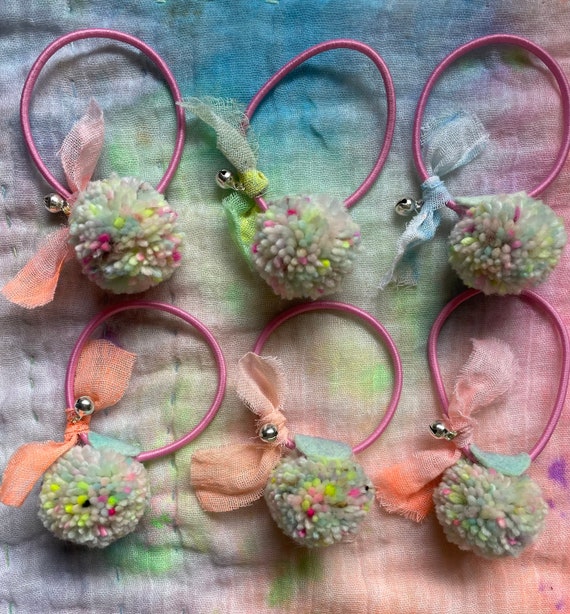 Mini Pom Pom with Muslin Bow and Jingle bell Hair Tie. Hand dyed Natural Fibres. Pastel Rainbow. Pick your bow colour.
