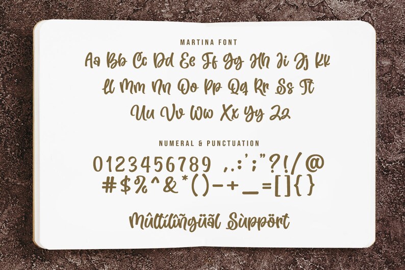 May include: A white sheet of paper with brown text showing the letters and numbers of the Martina font. The text includes the alphabet, numbers 0-9, and punctuation marks. The text also includes the phrase "M&ucirc;ltiling&uuml;al Support".