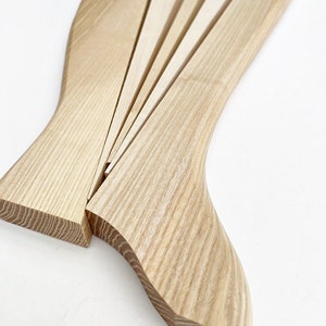 May include: A wooden wedge shaped tool with multiple pieces that can be used to separate wood.