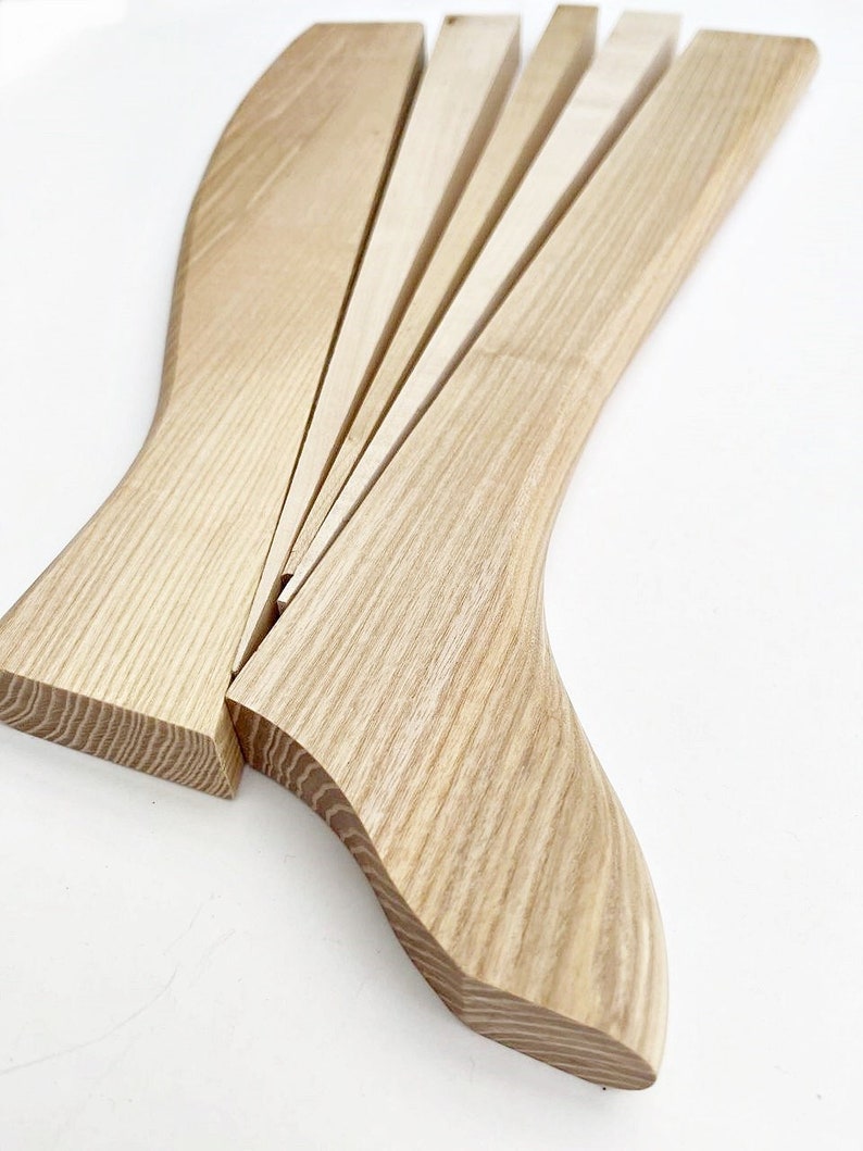 May include: A wooden wedge shaped tool with multiple pieces that can be used to separate wood.