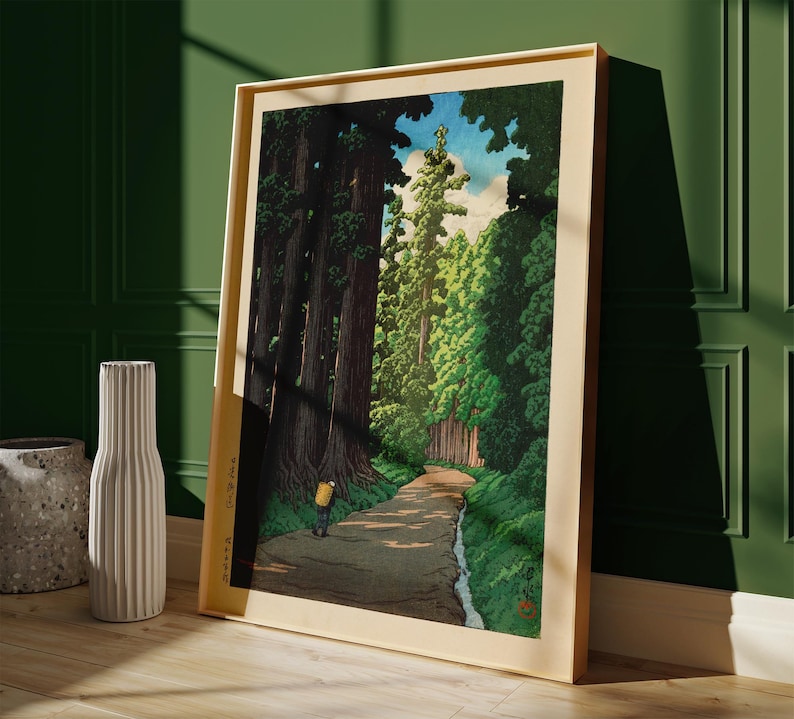 May include: A woodblock print showing a path through a forest of tall trees. The path is lined with trees on both sides, and there is a small stream running along the side of the path. A single figure is walking along the path.
