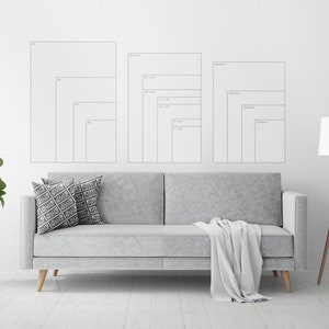 May include: A white wall with a gray couch and a floor lamp. There are three sets of framed prints on the wall, each with different sizes. The prints are labeled with measurements in inches. The text "JELLY MOOSE" is in the upper right corner of the image.