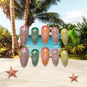 May include: A set of ten artificial nails with a tropical fruit design. The nails feature a variety of colors, including pink, green, orange, and yellow, with a white base and a clear, glossy finish. The background shows a beach scene with palm trees and a blue ocean.