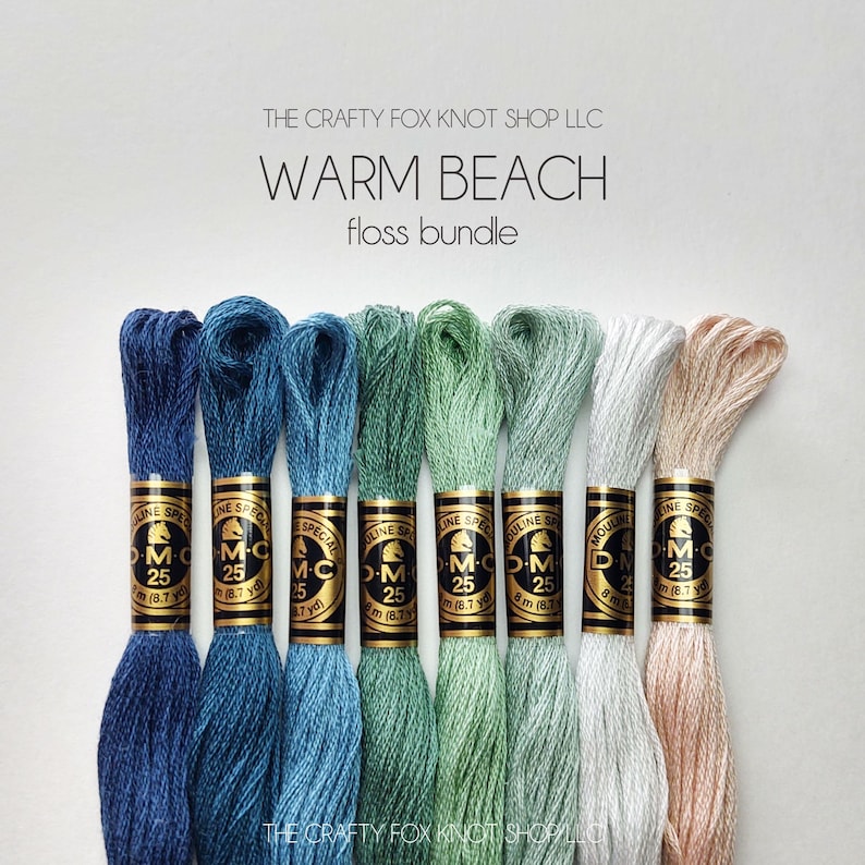 May include: A set of six embroidery floss spools in shades of blue, green, and beige. The spools are labeled "DMC" and "Mouline Special". The text "Warm Beach floss bundle" is printed above the spools.