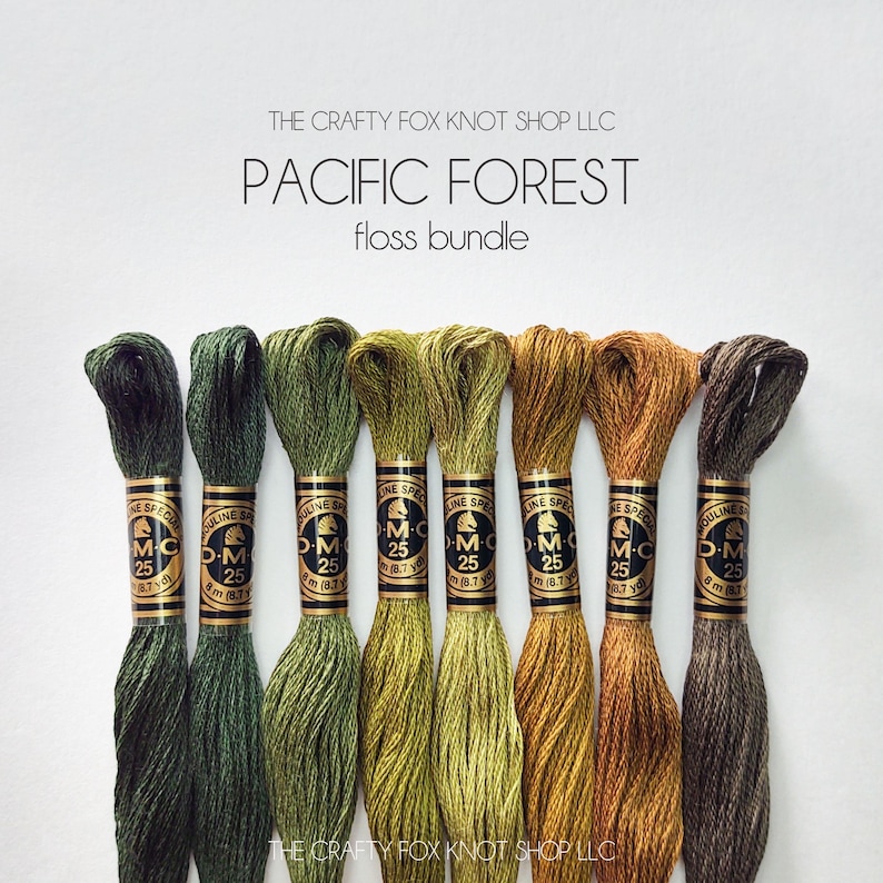 May include: A set of eight DMC embroidery floss spools in shades of green, yellow, and brown. The spools are labeled "DMC" and "25". The text "PACIFIC FOREST floss bundle" is displayed above the spools.
