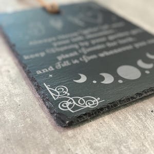 May include: Black slate sign with white text and moon phases. The text reads "Always trust your gut, keep chasing the moon, and fall in love wherever you go."
