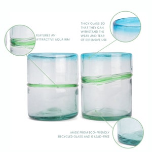 May include: Two clear glass tumblers featuring an aqua blue rim and a horizontal green glass band around the center. The text on the image highlights features: Features an attractive aqua rim, thick glass so that they can withstand the wear and tear of extensive use, and made from eco-friendly recycled glass and is lead-free.