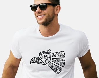 May include: White t-shirt featuring a black and white graphic of an eagle's head. The eagle design is segmented and filled with intricate patterns. The person in the image is wearing black sunglasses.