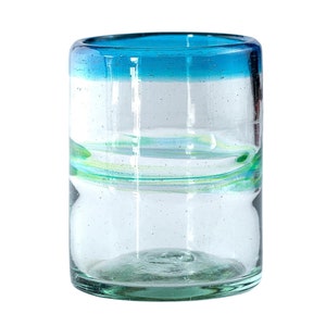 May include: A cylindrical clear glass tumbler featuring a vibrant blue rim and a subtle horizontal swirl of light green glass embedded within the body. The glass has a slightly textured surface with small air bubbles throughout the material.