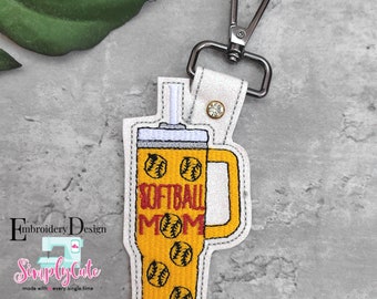 May include: Yellow and red embroidered keychain with a design of a tumbler with a straw and the text "Softball Mom" and baseballs.