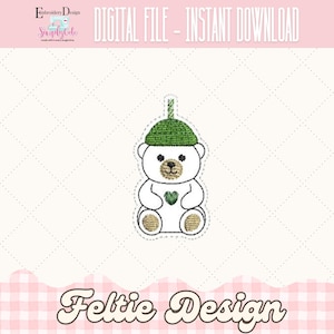 May include: Embroidered design of a white teddy bear wearing a green hat and holding a green heart. The text "DIGITAL FILE - INSTANT DOWNLOAD" is at the top. The text "Feltie Design" is at the bottom.
