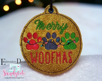 May include: Gold glitter Christmas ornament with the text "Merry Woofmas" and three paw prints with colorful lights.