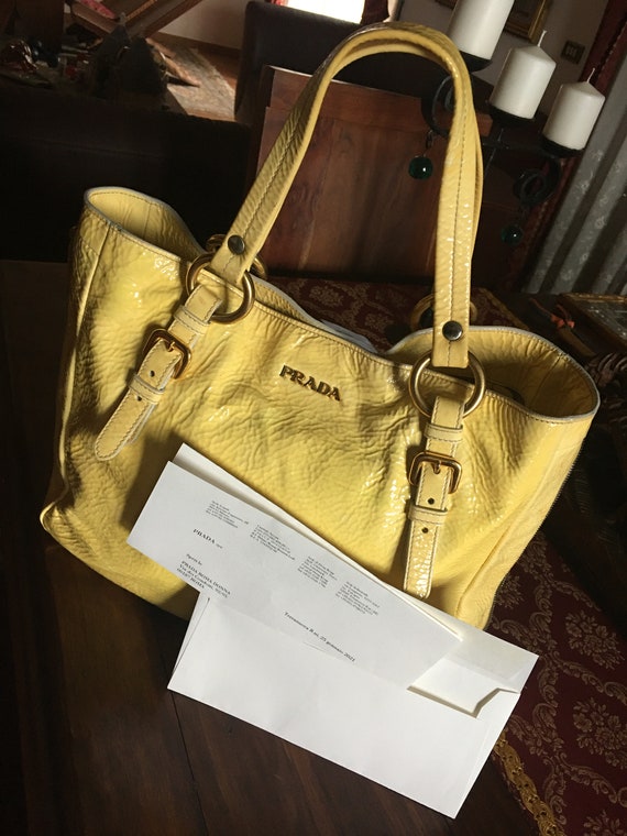 Buy the Prada Yellow Debossed Long Wallet COA | GoodwillFinds