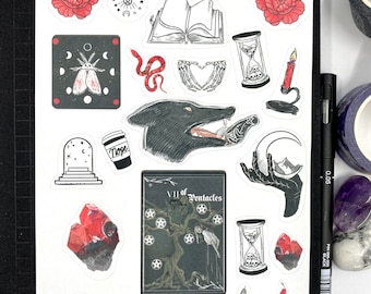 May include: A collection of stickers with a gothic and mystical theme. The stickers feature illustrations of a wolf, snakes, tarot cards, hourglasses, crystals, and flowers. The text "KILLERVIEWS" is also present.