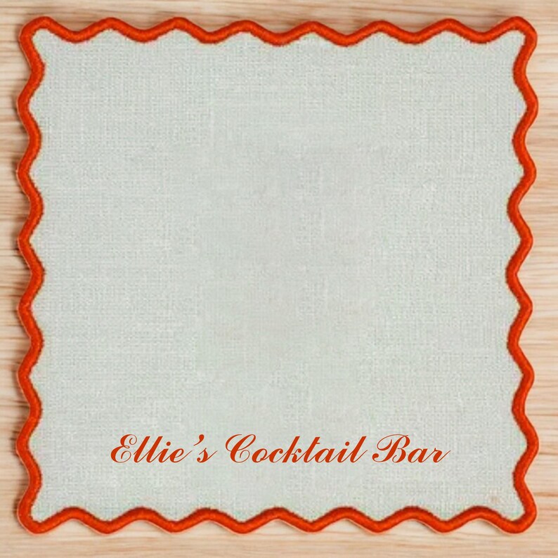 May include: A white square coaster with a red scalloped border. The text "Ellie's Cocktail Bar" is printed in red on the coaster.