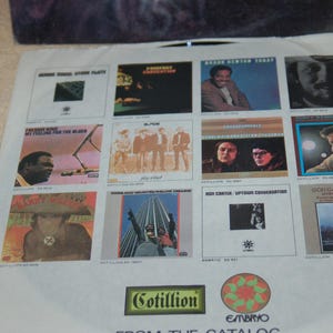 May include: A vintage record album cover with a collage of album covers featuring various artists. The album covers are all black and white and feature a variety of musical genres. The album cover is titled "From The Catalog" and features the Cotillion and Embryo logos.