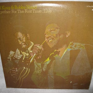May include: Album cover for "Together For The First Time... Live" by B.B. King & Bobby Bland. The cover features a sepia-toned image of the two musicians. The text on the cover reads "A Two-Record Set" and "MCA Records".